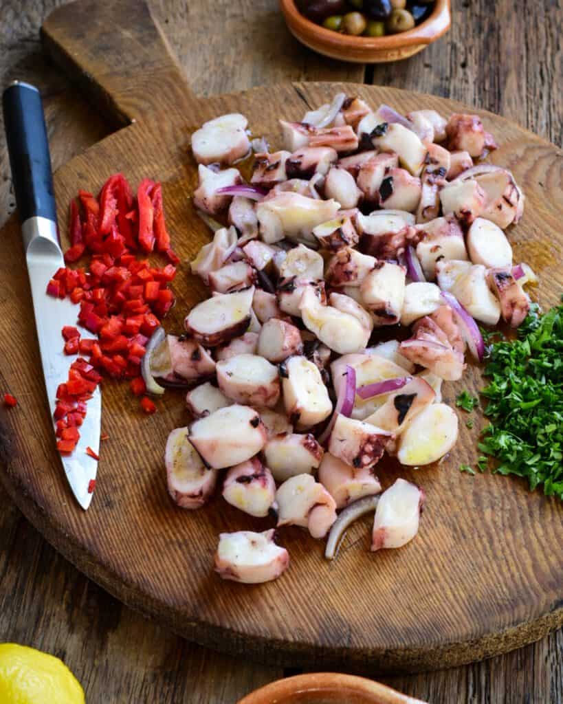 Ingredients for a marinated squid salad laid out on cutting board.