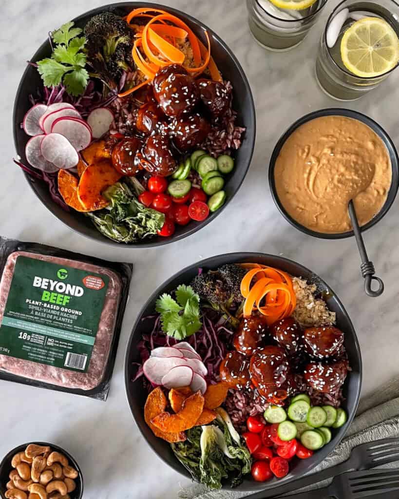 Two Beyond Meat Thai Meatball Bowl with a package of Beyond Beef, Plant-Based Ground and a bowl of peanut sauce.