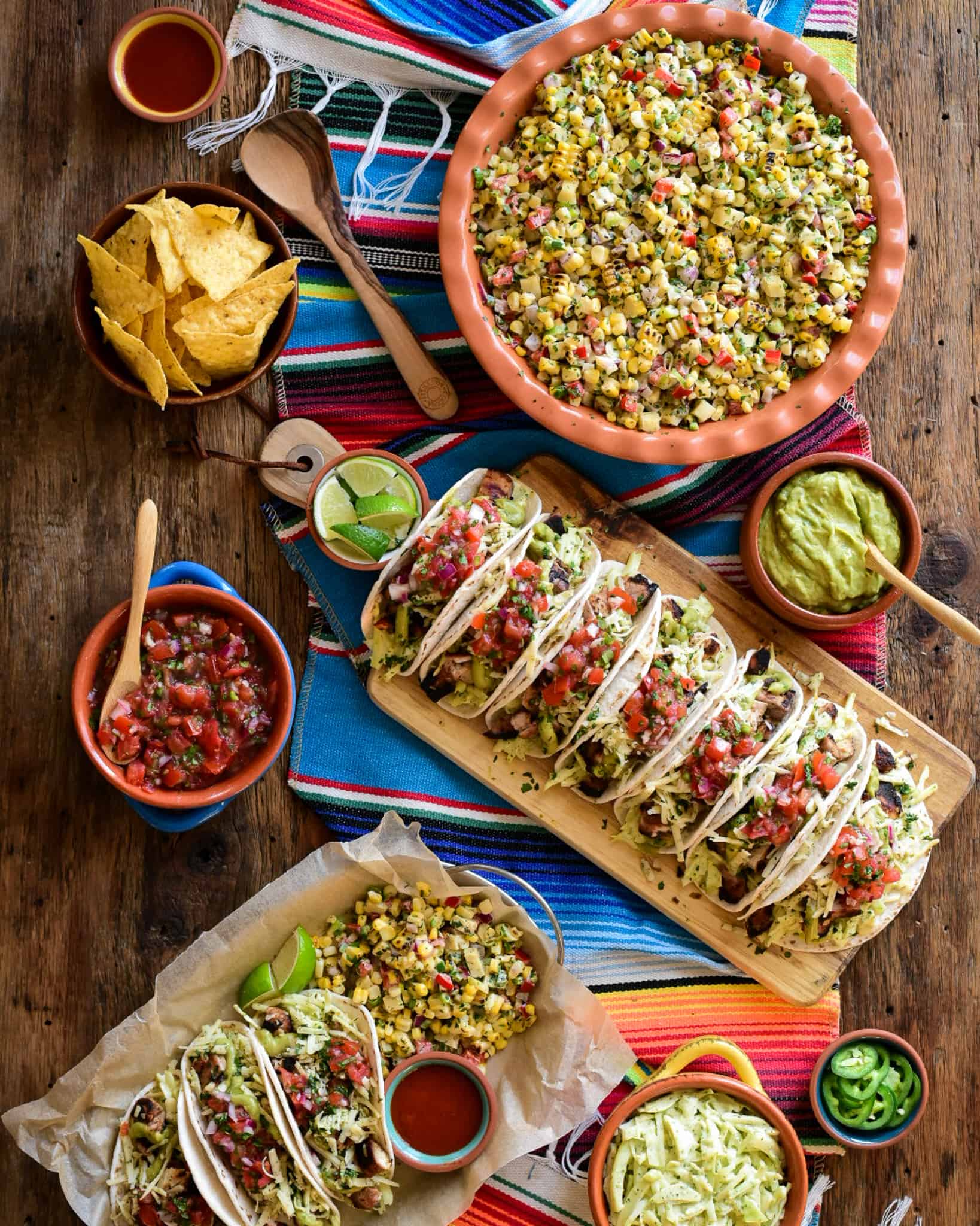 A Cinco de Mayo celebration with chicken tacos and a Mexican grilled corn salad. Served with chips, salsa and guacamole.