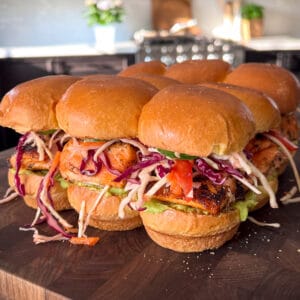Nine salmon sliders with a colourful coleslaw and guacamole.