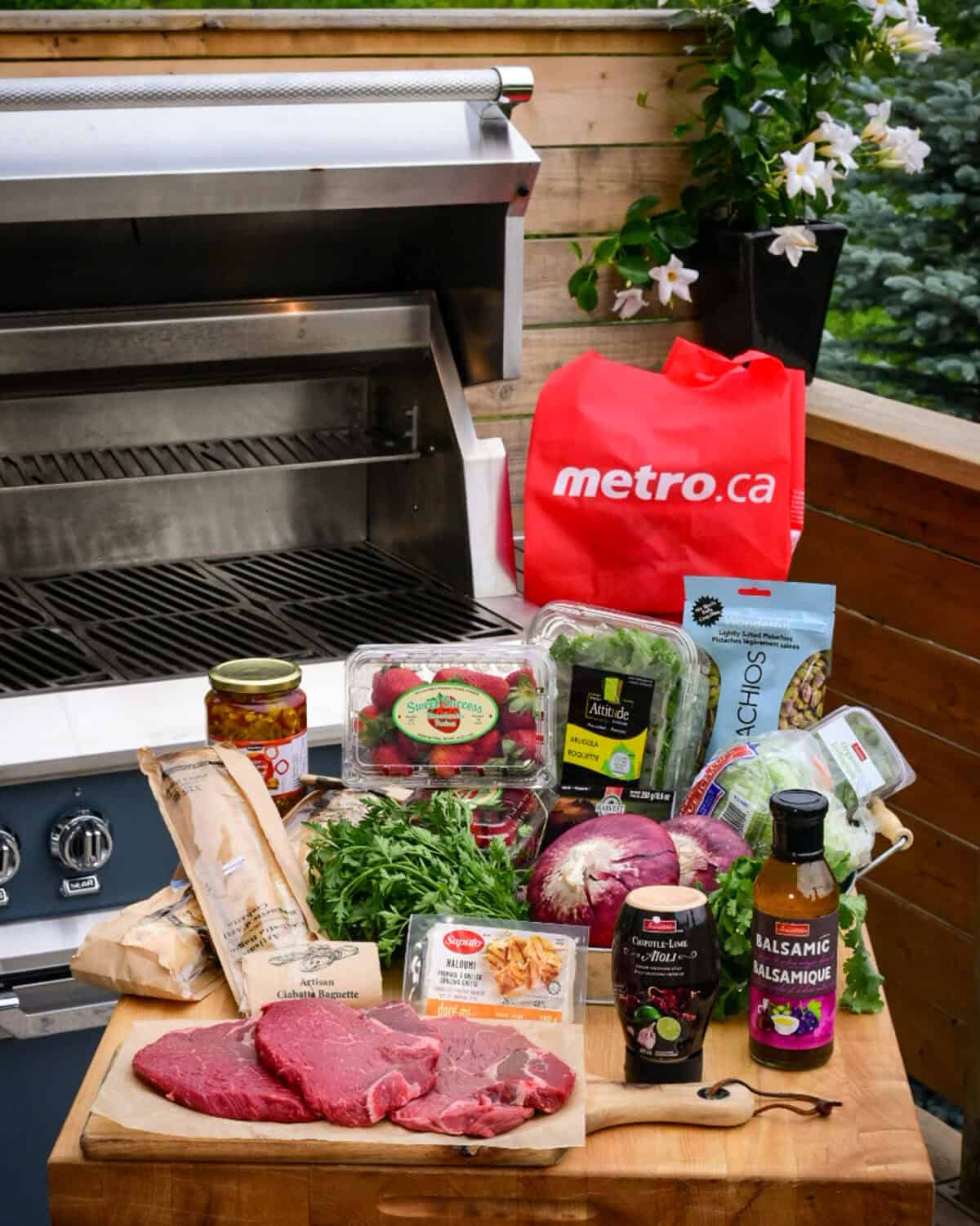 A table filled with ingredients to make a grilled sandwiches and a salad.