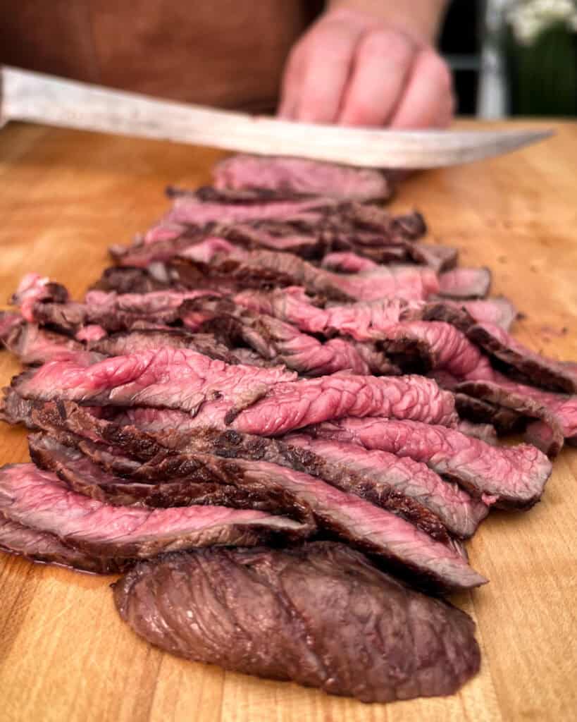Slicing steak across the grain for a sandwich.