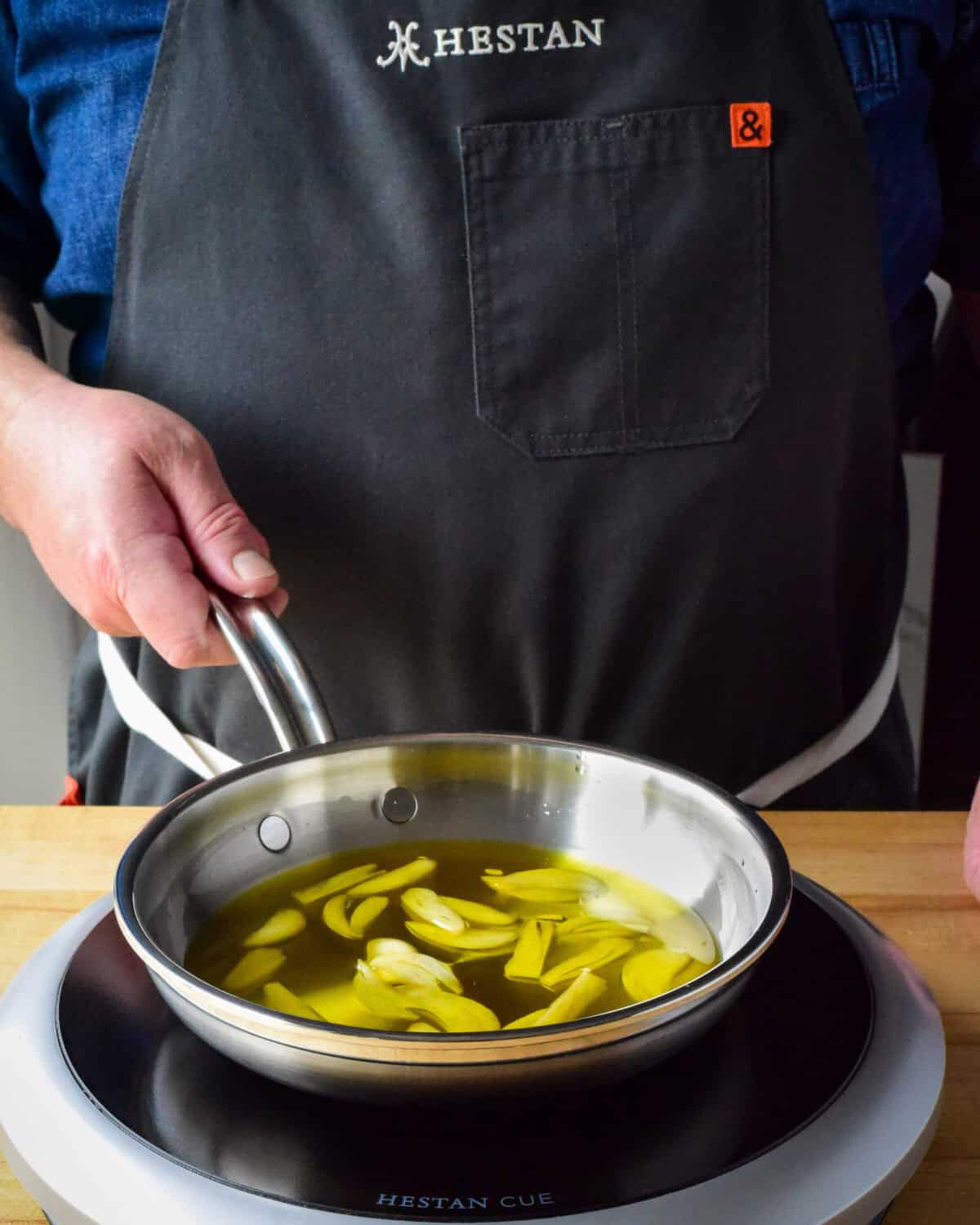 Oil and garlic simmering in a pan.