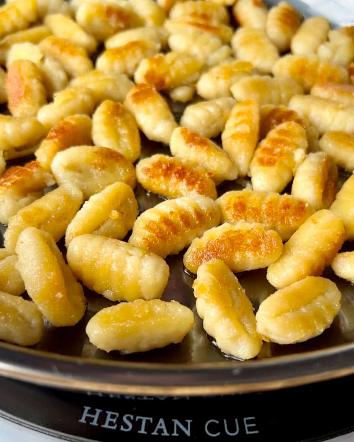 A skillet of browned gnocchi.