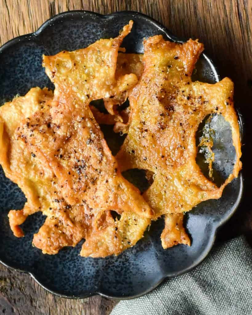 A plate of crispy chicken skin chips.