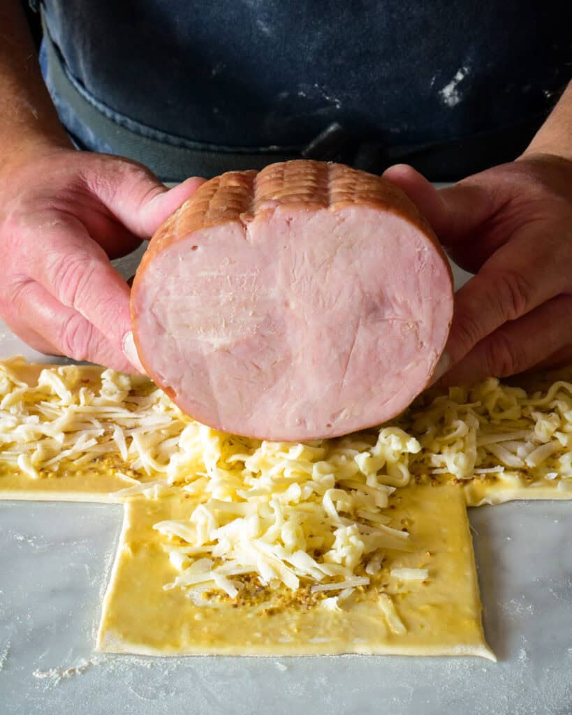 Place the ham upside down in the centre of the pastry, with the cut side facing the shorter piece of the “+”.