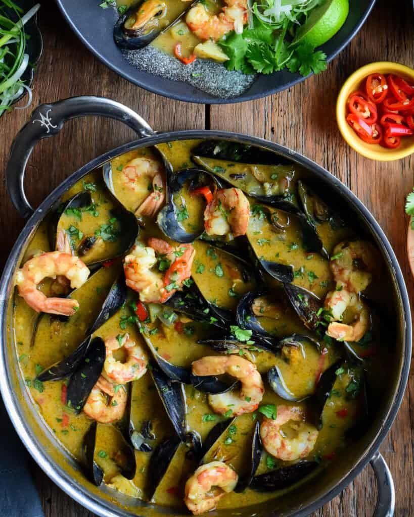 A close up of a pot of seafood curry.