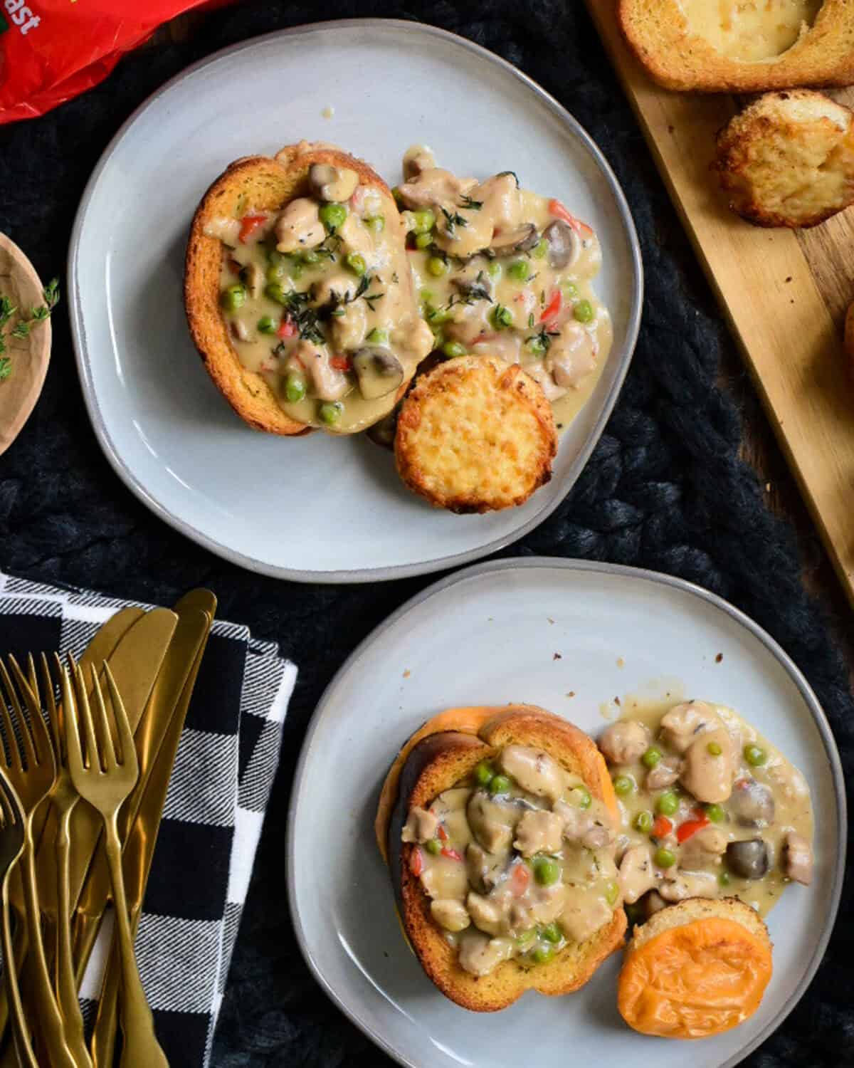 Two plates of Chicken à la King on Toast; one for an adult with Smoked Gouda cheese and one for a child using process cheese.