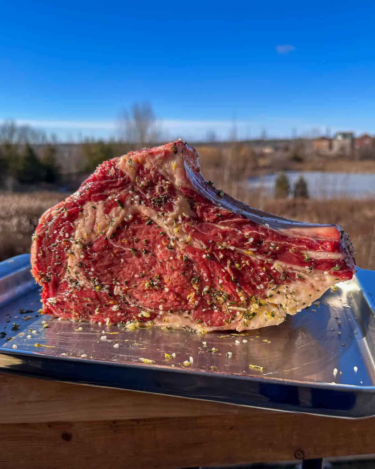 A 3 inch ribeye marinated in oil and herbs.