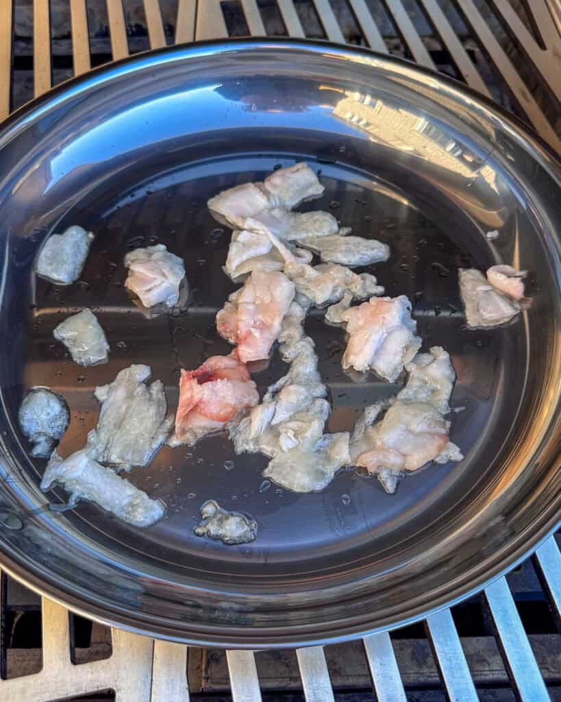 Add the fat trimmings to the skillet.