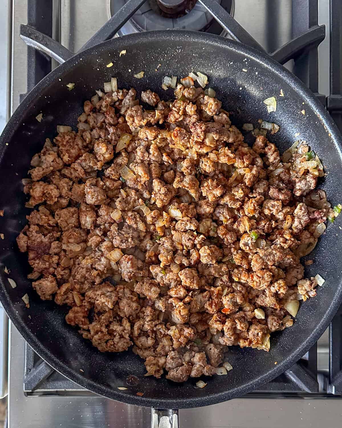 Adding spices into the sausage mixture for spicy nachos.