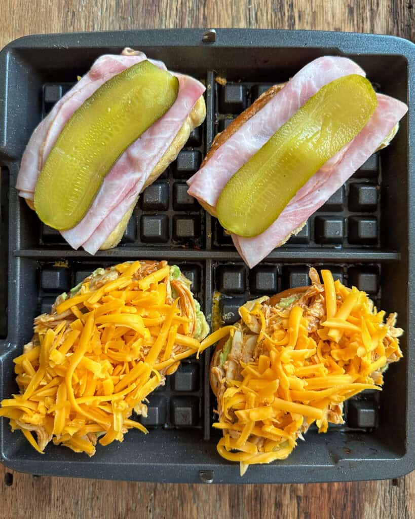 Building the ham and cheese and BBQ chicken paninis in the waffle maker.