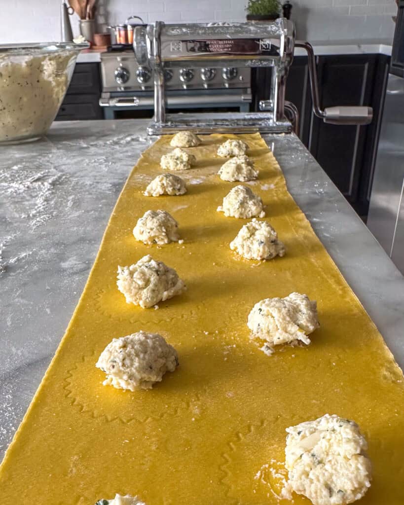 Place ½ tablespoon of the cheese filling onto one pasta sheet, leaving space between each mound.