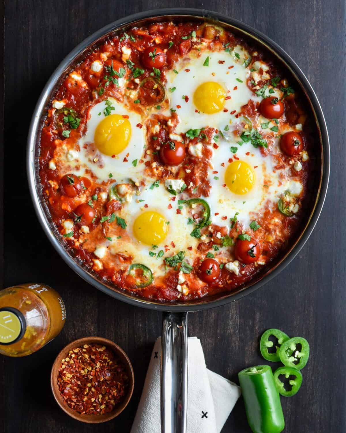A skillet of spicy shakshuka - eggs in tomato sauce