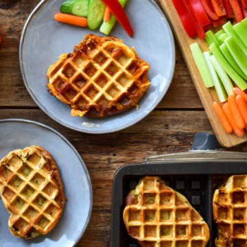 Waffle iron panini served with veggies.