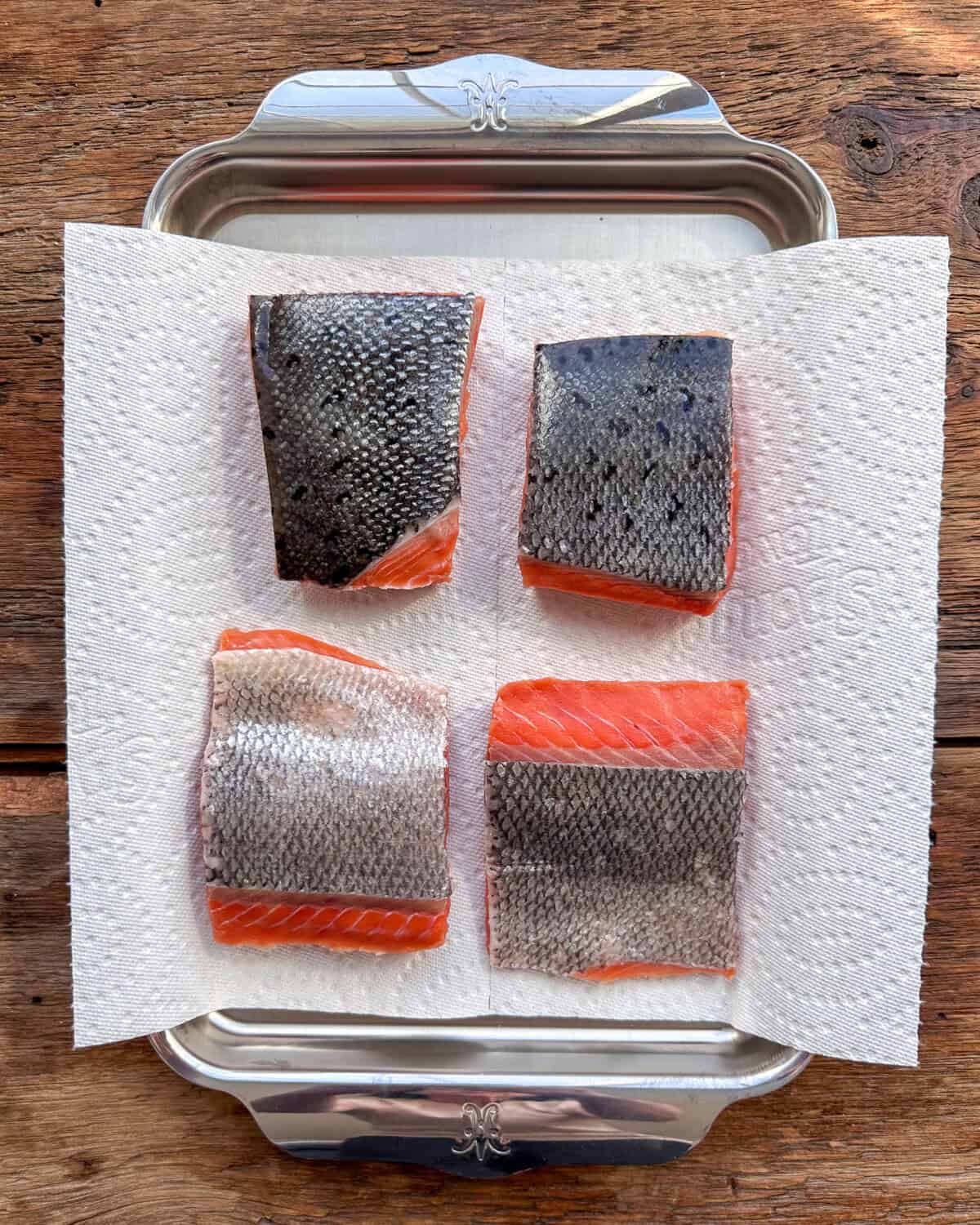 Dry four pieces of King Ora Salmon with skin on paper towels.