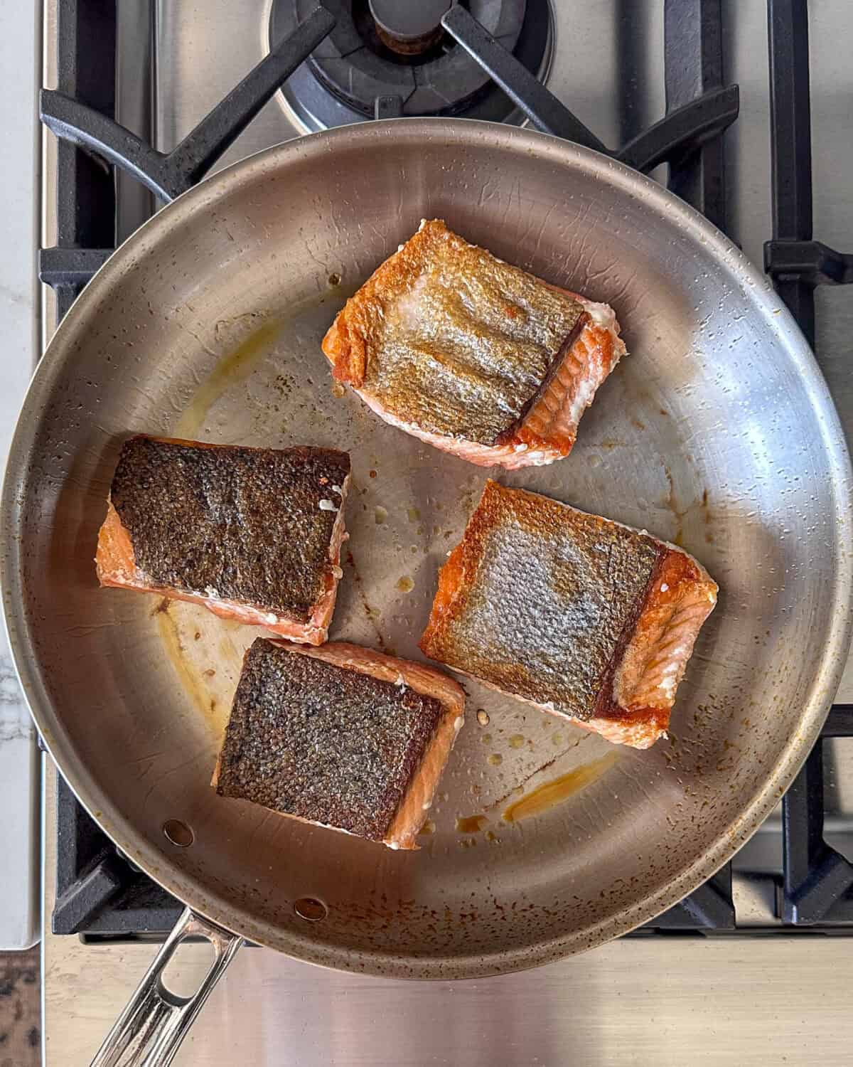 Carefully flip the salmon to quickly cook the flesh side of the fish, 30 to 60 seconds.