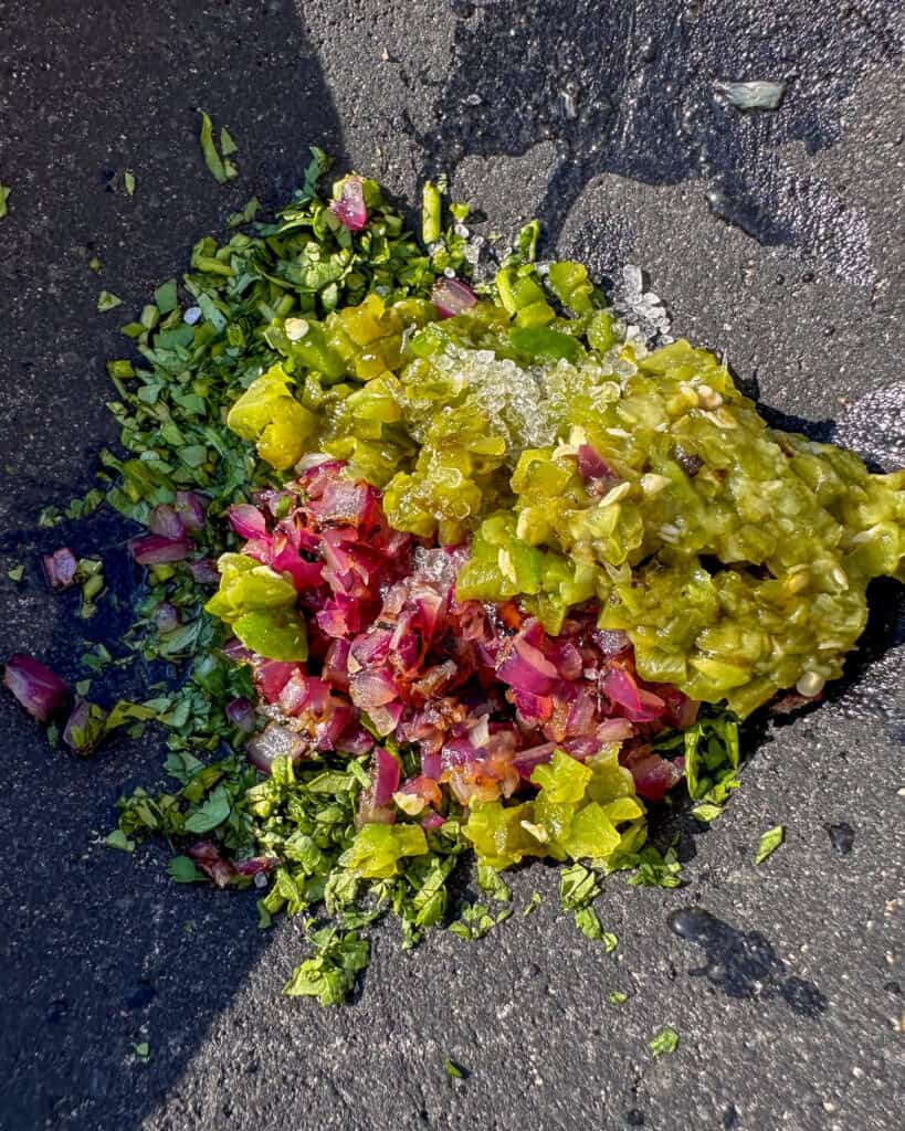 Mash the onion, jalapeno, cilantro, salt, lime juice and olive oil in the molcajete.