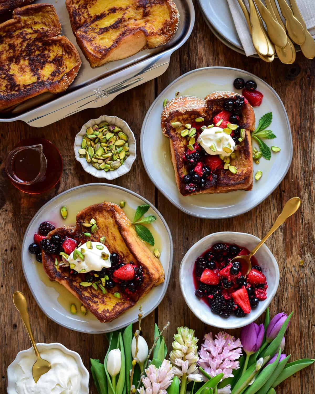 Two plates of Challah French Toast with Mascarpone and Berries.