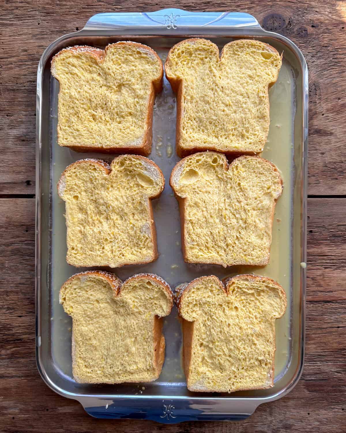 Arrange challah slices on a baking sheet. Pour the custard over the bread and let sit at room temperature.