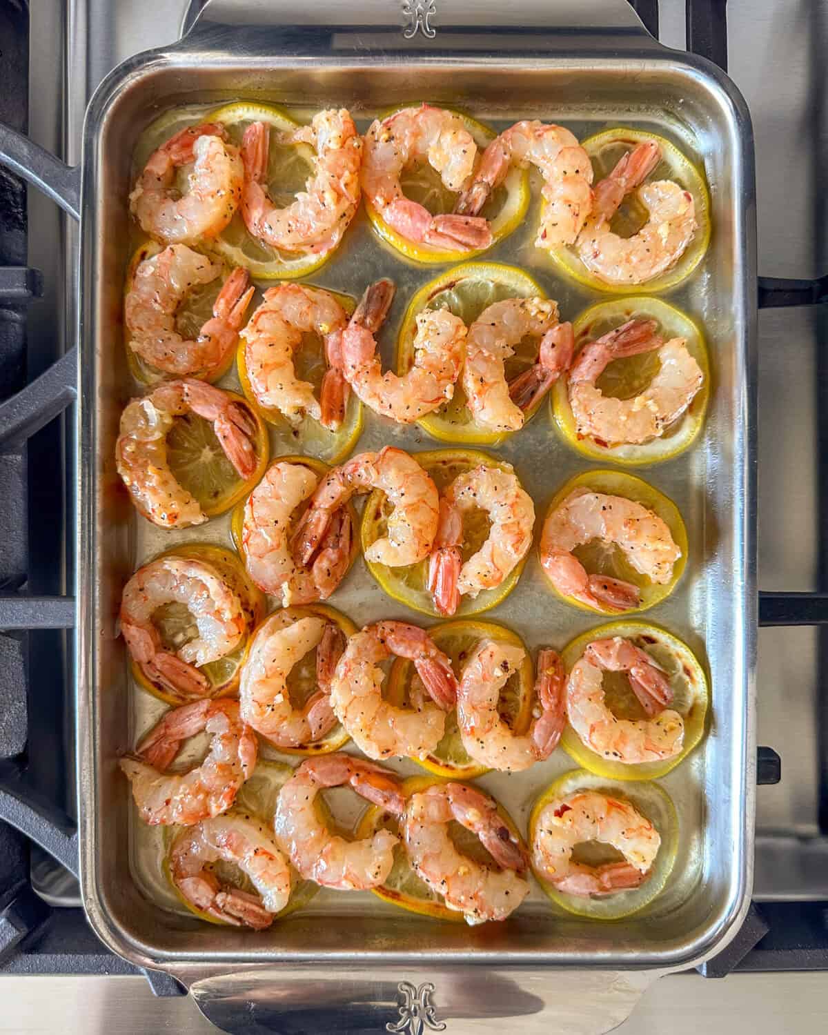 Place the shrimp in an even layer on top of the lemon slices.