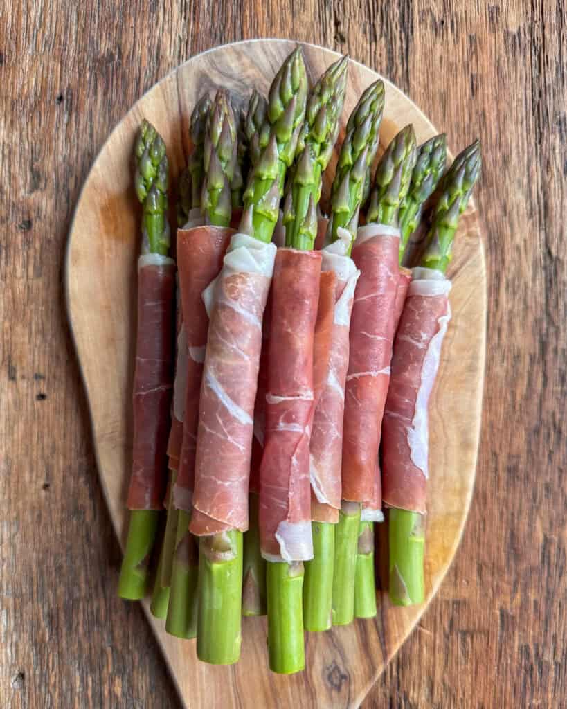 Prosciutto wrapped asparagus ready to be air fried.