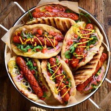 A tray filled with colourful Grilled Smokie Pizza Sandwiches.