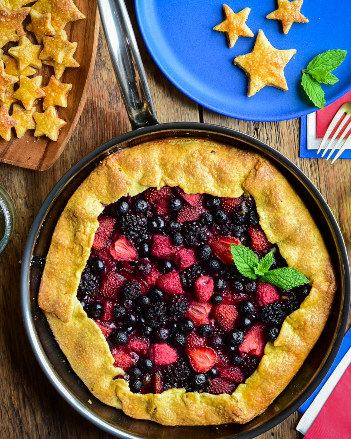 A grilled mixed berry galette served with stars made from the crust.