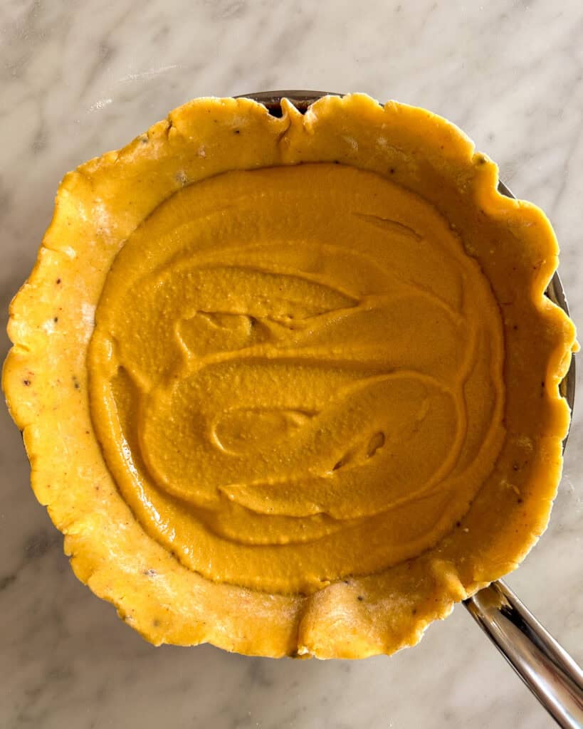 A gallet crust in a pan with frangipane in the centre.