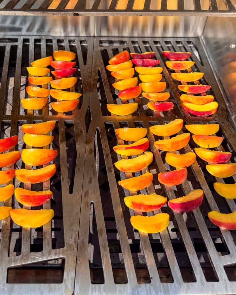 Place the peach slices on the grill and cook for 2-3 minutes per side, until grill marks appear and the peaches are slightly softened.