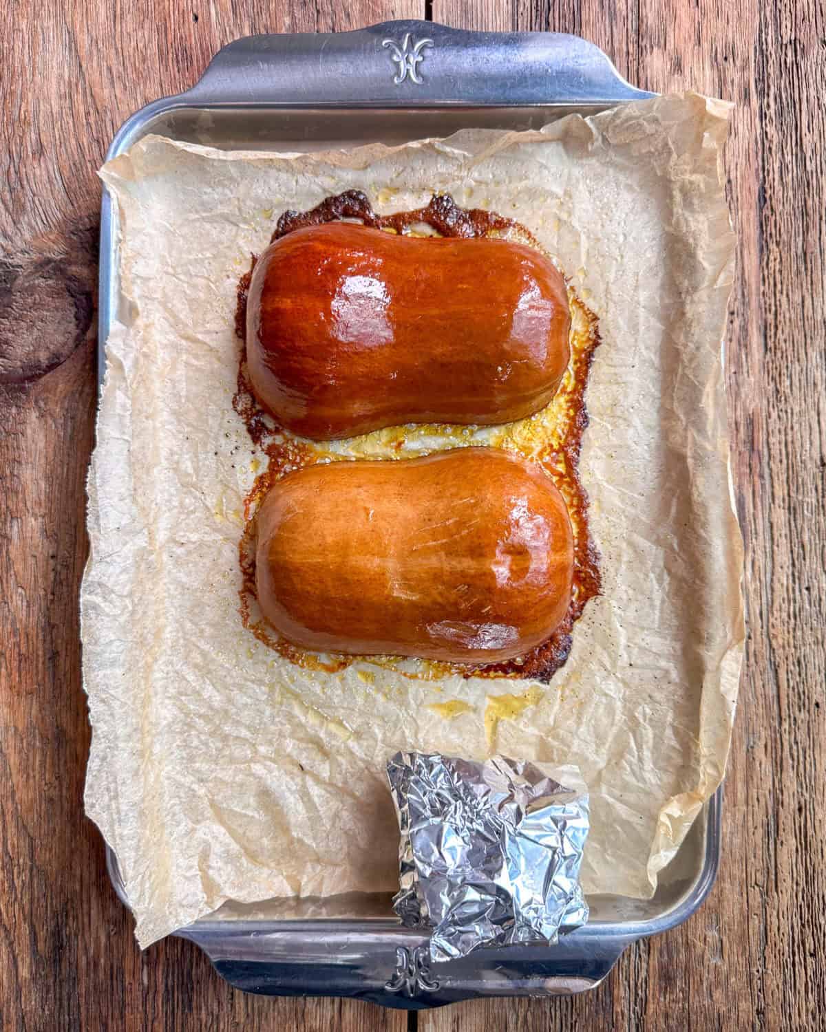 Two roasted honeynut squash halves, cut side down.