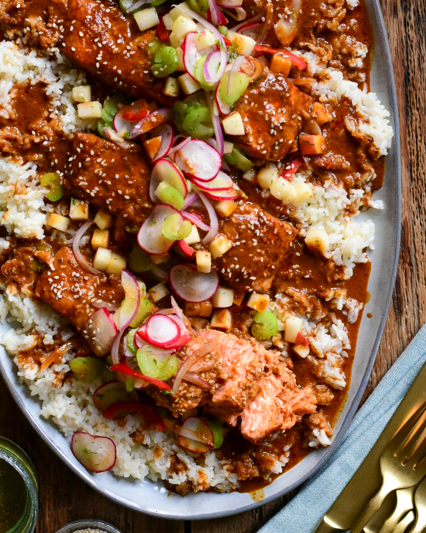 A plater with Baked Curry Salmon with Coconut Rice and and apple salsa.