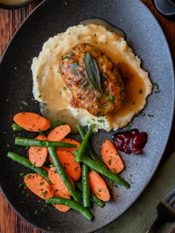 Mini turkey meatloaf with Paxo served with mashed potatoes, gravy and vegetables.
