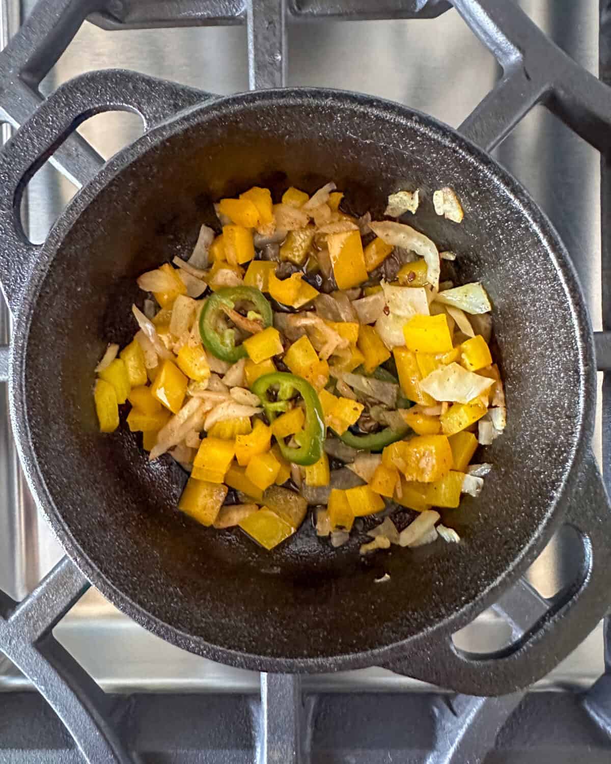 A cast iron skillet with sautéed veggies.