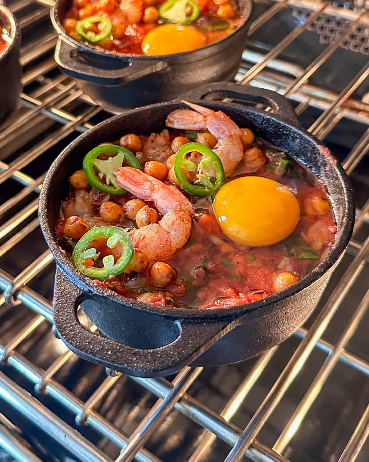 A shrimp shakshuka going into the oven to get baked.