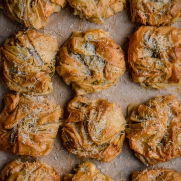 A close up of twelve savory Surf and Turf Phyllo Bundles.