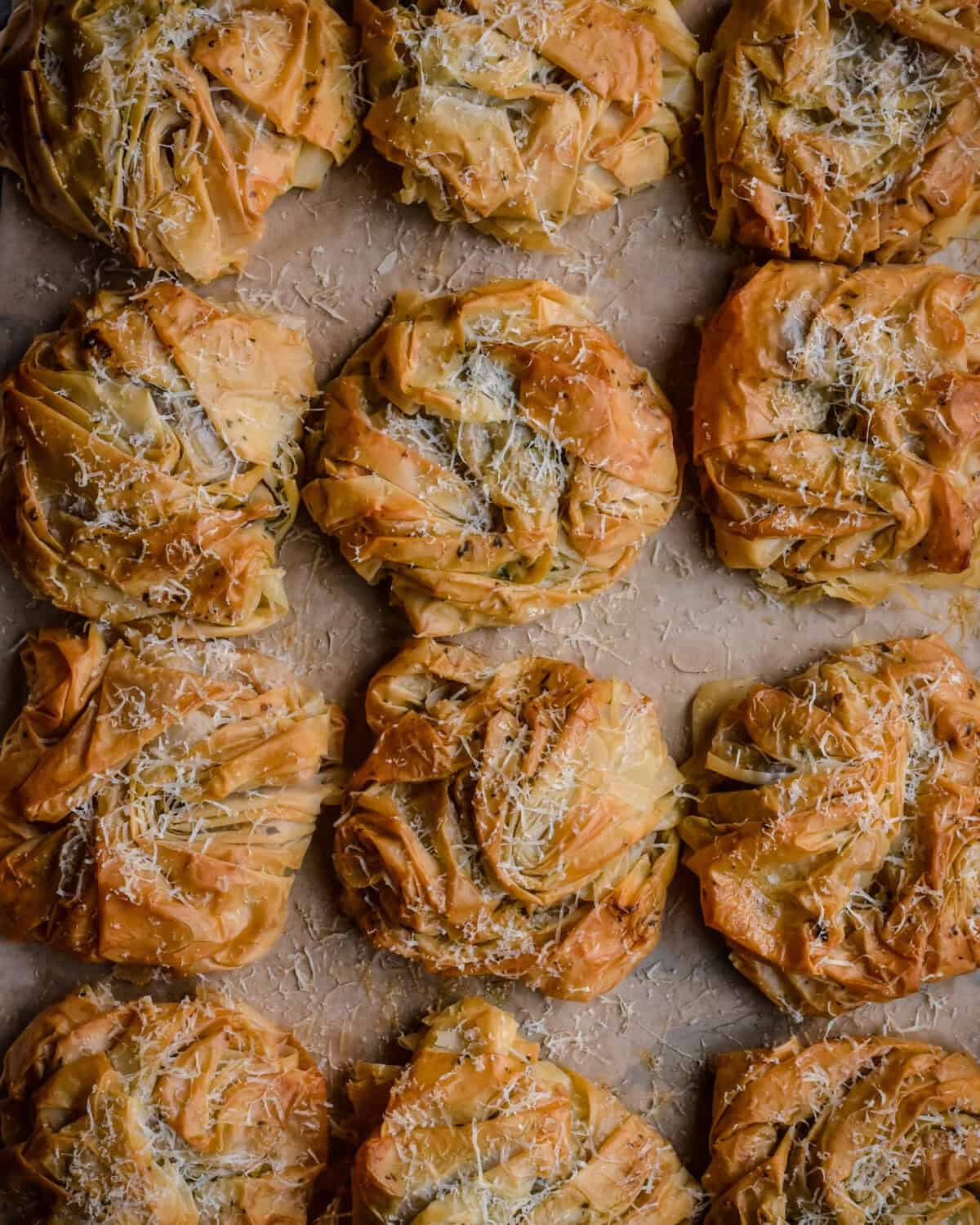 A close up of twelve savory Surf and Turf Phyllo Bundles.