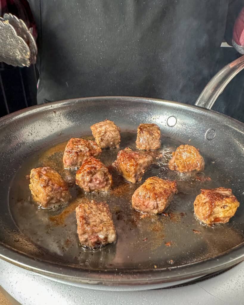 Sear the beef in batches, browning all sides