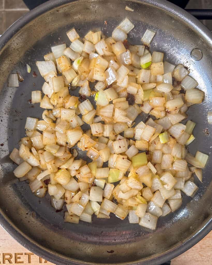 Add the chopped onions to the skillet and sauté for 2-3 minutes until softened.