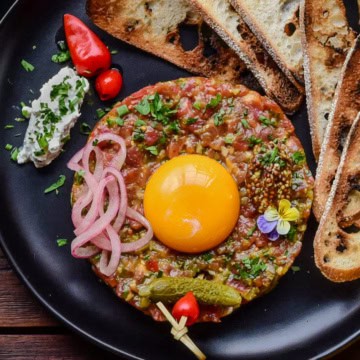 Steak tartare with a raw egg yolk - raw steak appetizer
