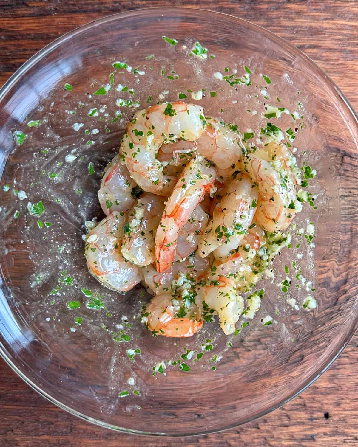 In a small bowl, toss shrimp with 2 tablespoon of the garlic butter mixture and a dash of pepper.