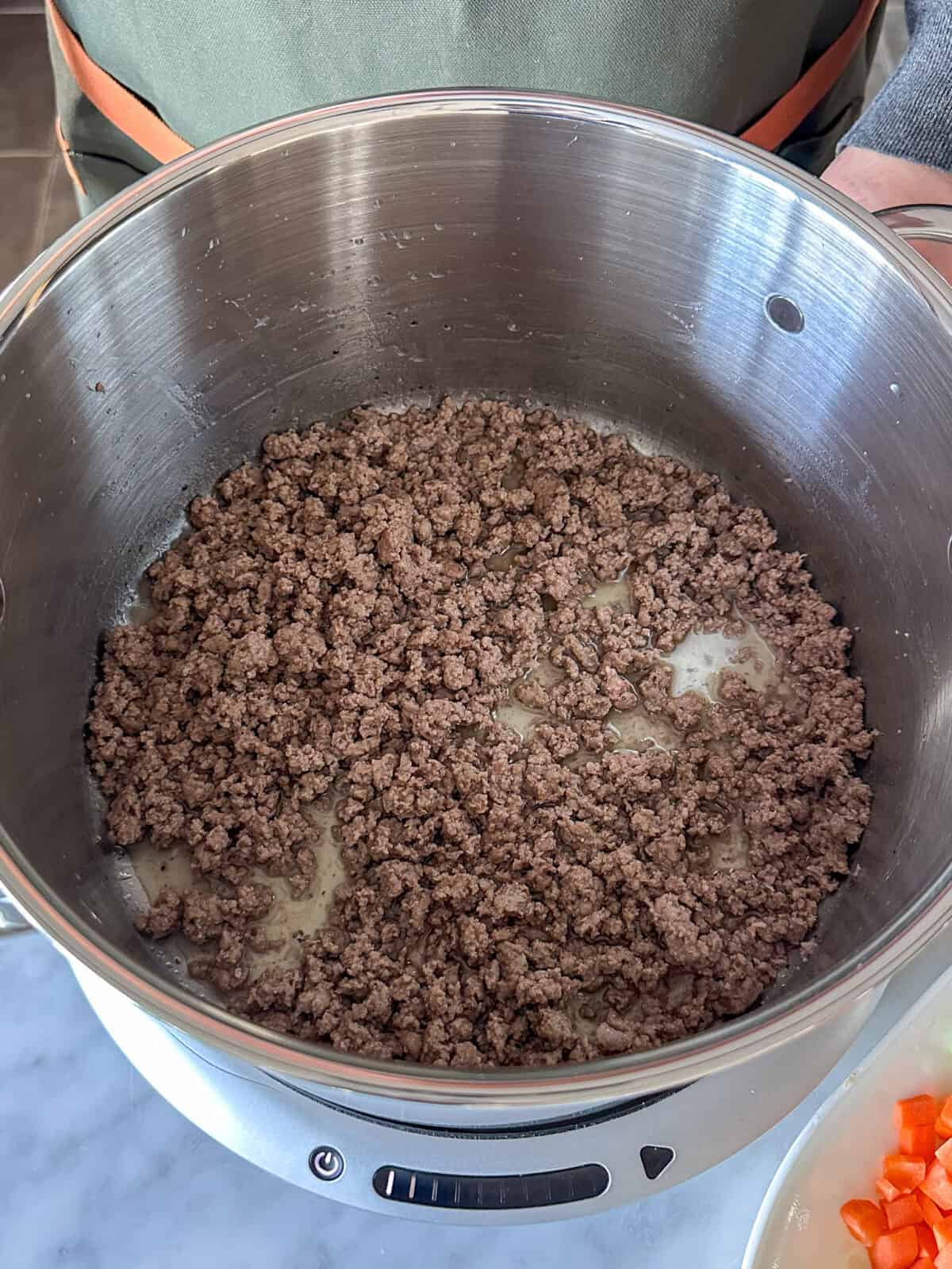 Brown the ground beef in the pot.
