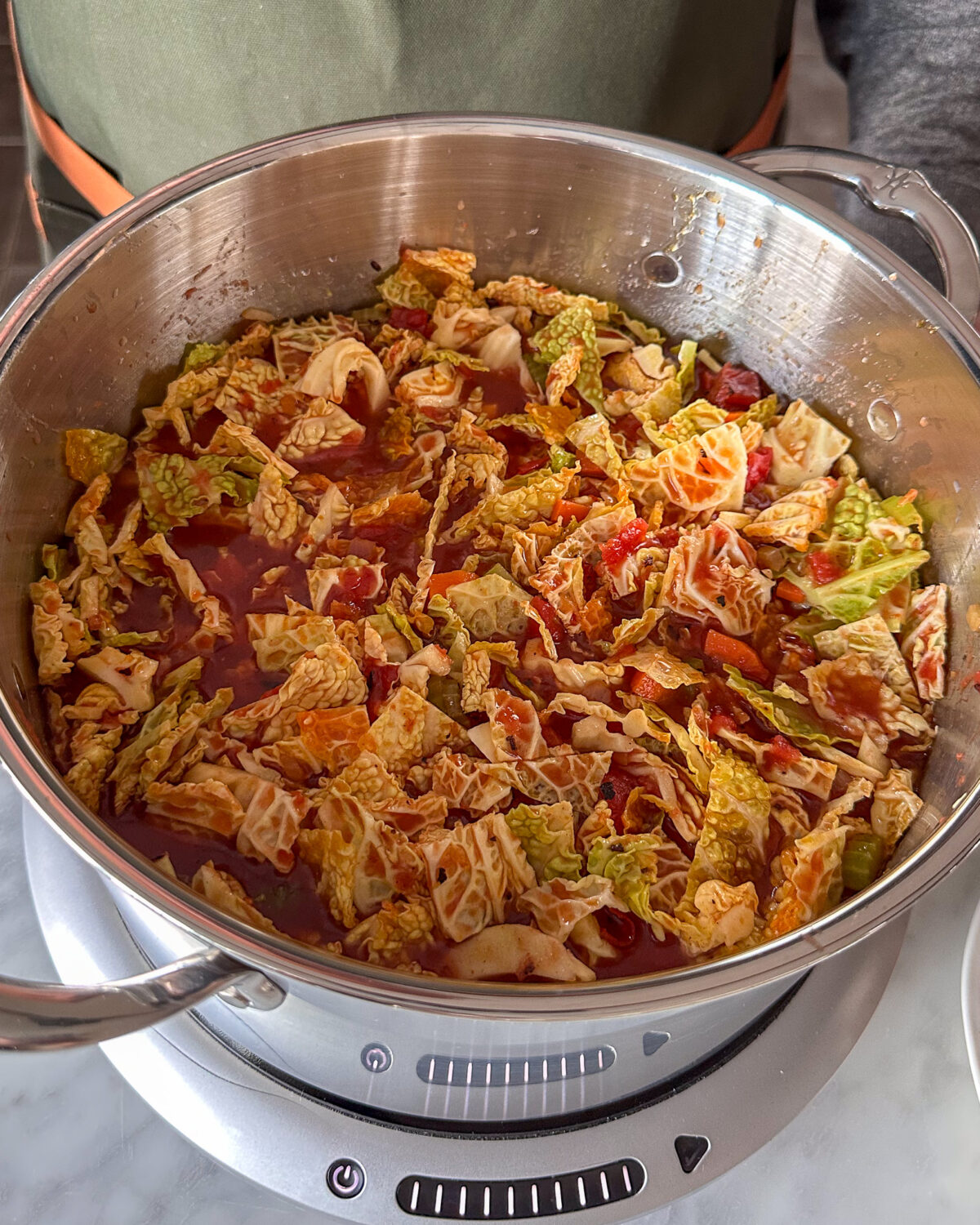 Stir in the chopped cabbage, crushed tomatoes, tomato paste, Worcestershire sauce, and remaining broth. Bring to a gentle boil,