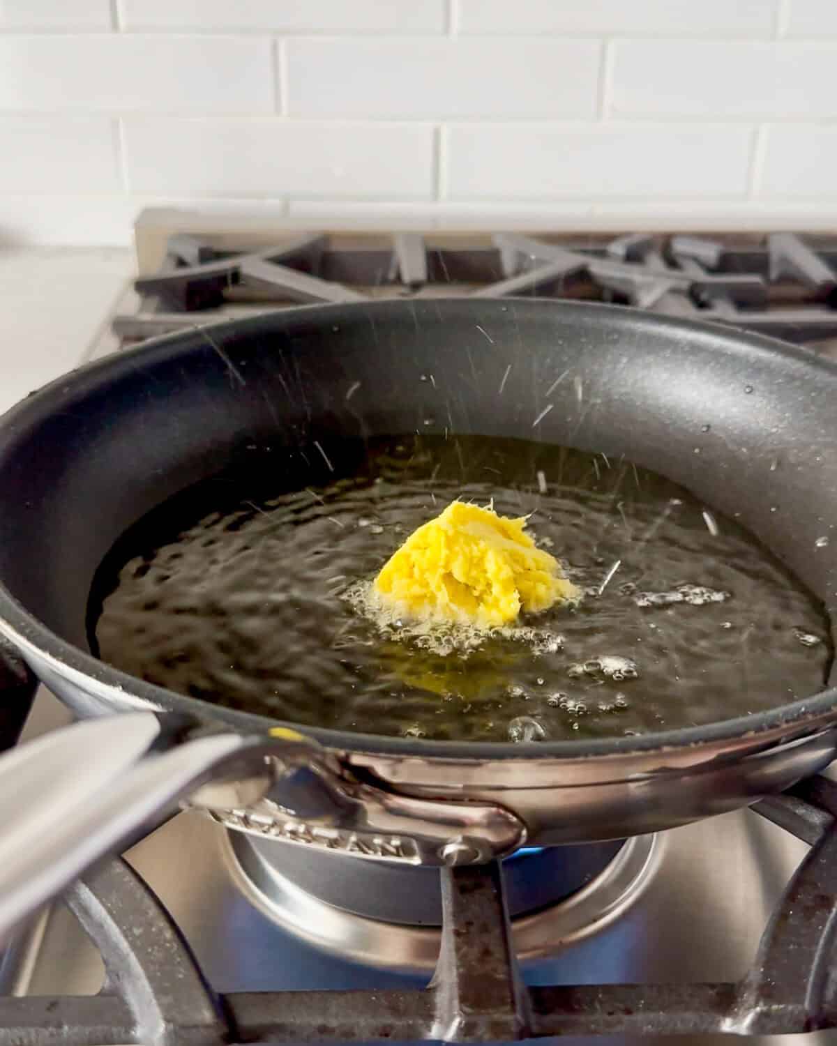 Add the grated ginger to the hot oil.
