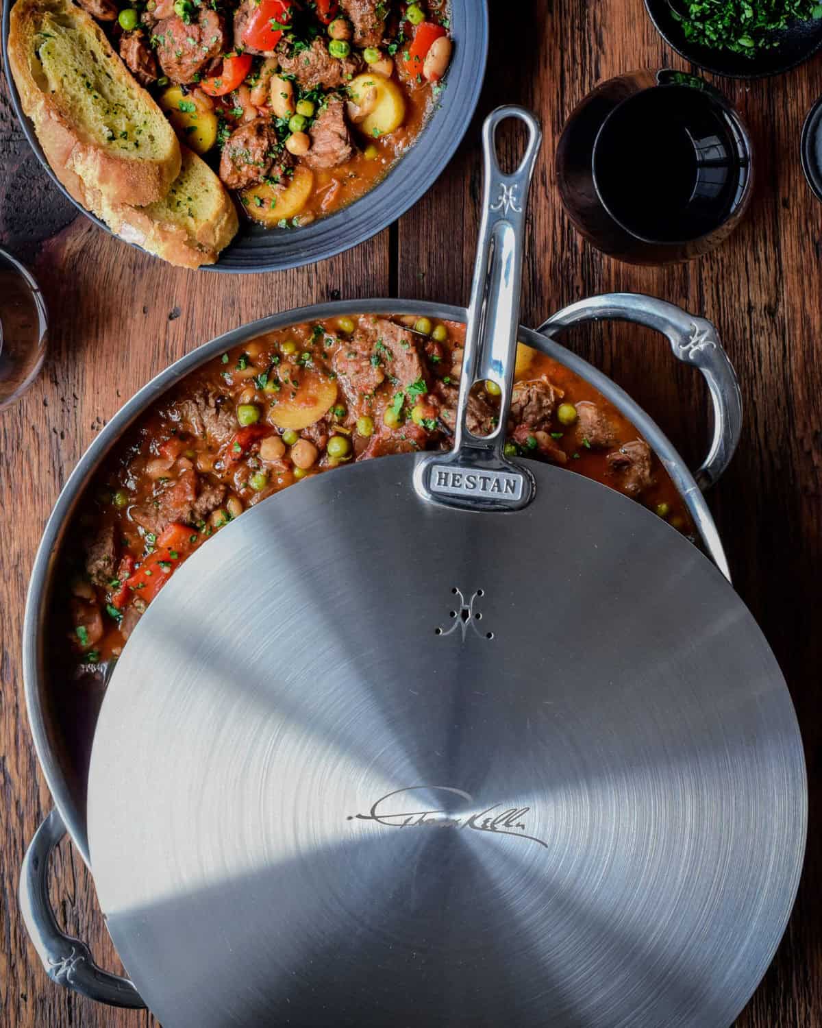 This Spanish lamb stew recipe was made using our Hestan Culinary Thomas Keller 9-QT Rondeau, 12.5” Universal Lid and Chef’s tools.