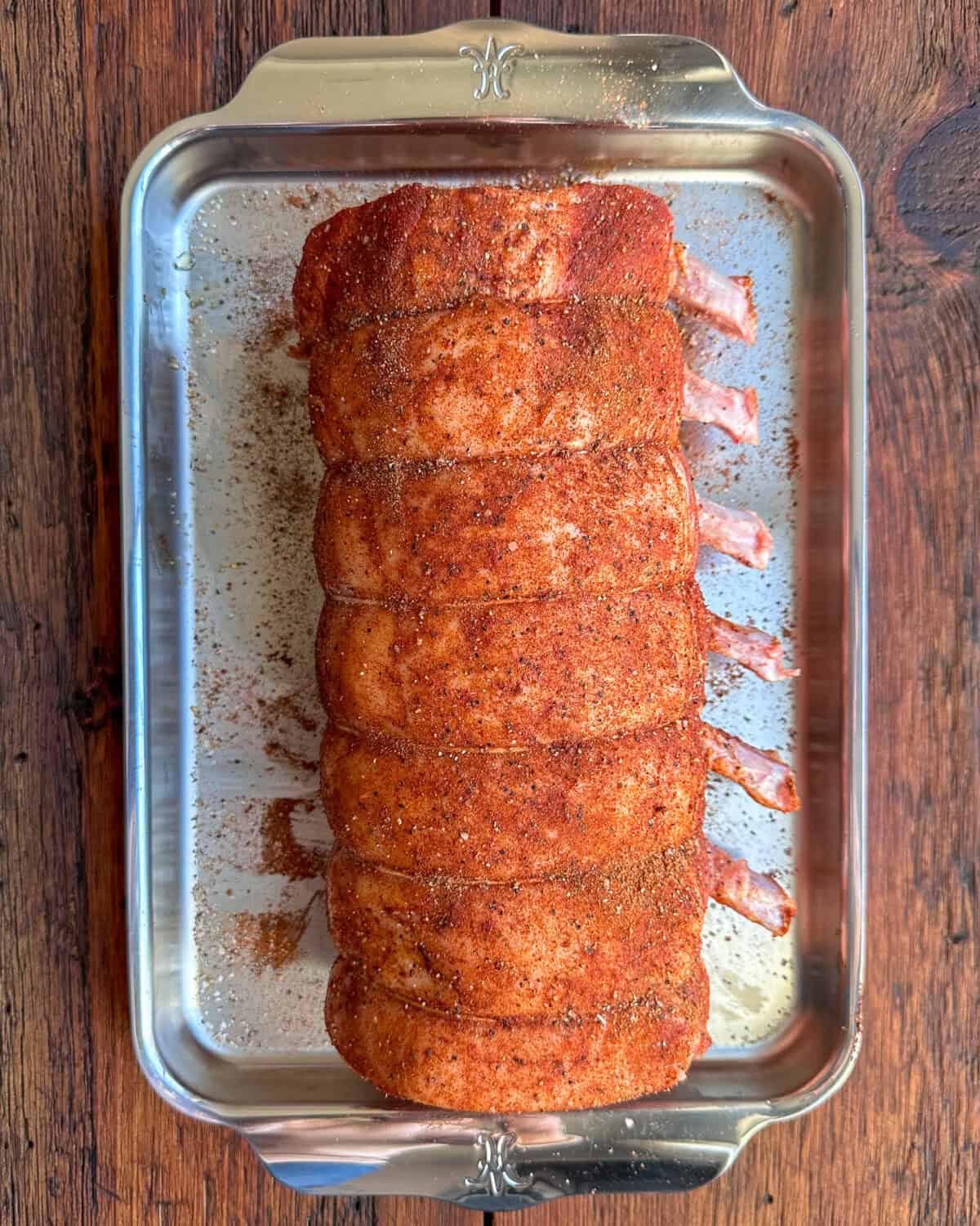 Apply the dry rub over the pork roast.