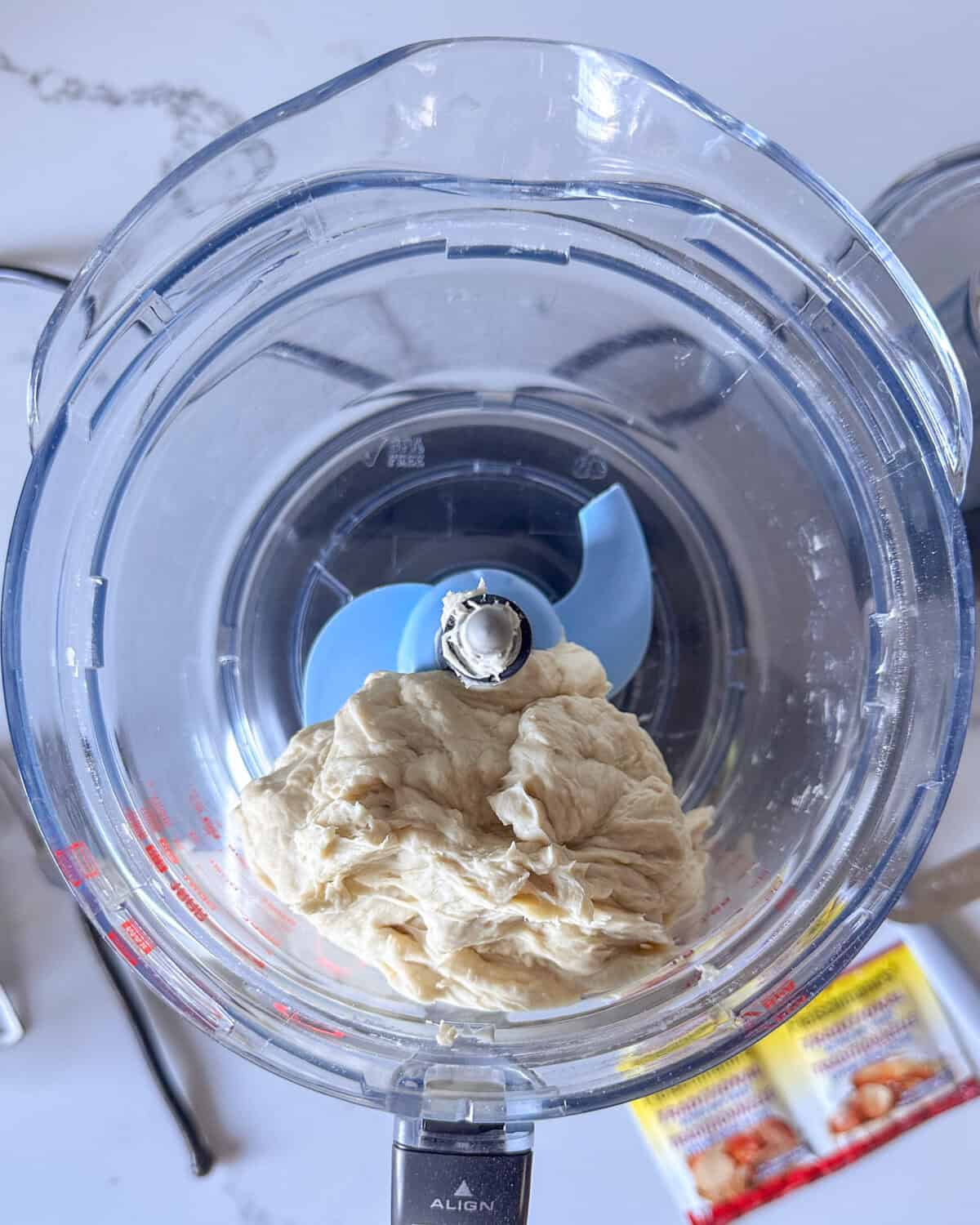Combine the sheet pan pizza dough ingredients in food processor and mix until it forms a dough.