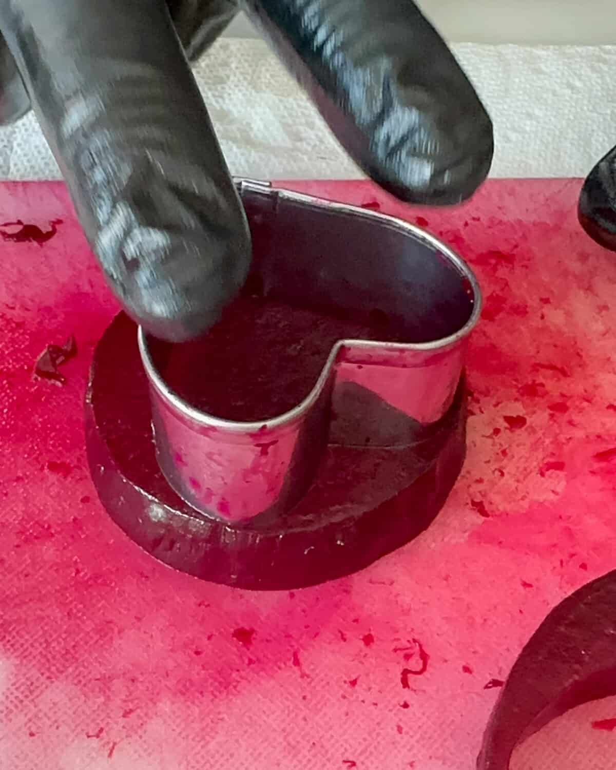 Use a small cookie cutter to cut out hearts in a beet slice.