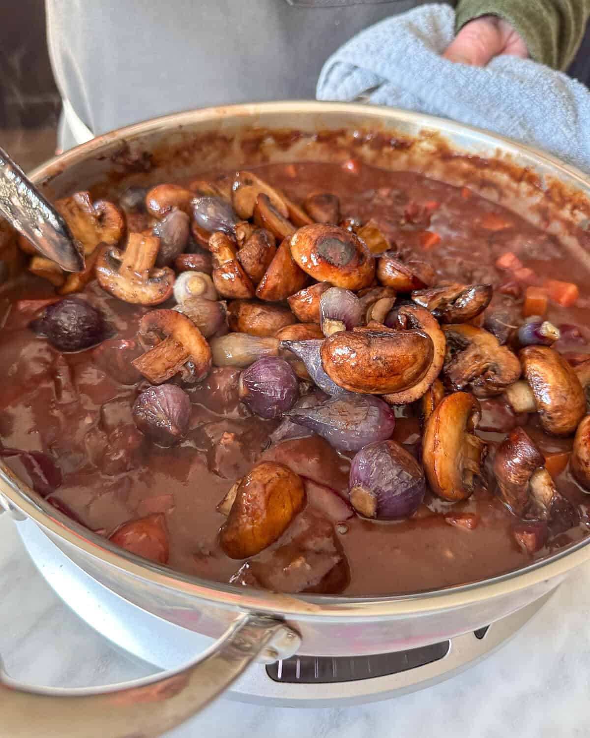 Stir in the roasted beets, mushrooms, pearl onions, and the remaining pancetta into the Beef Bourguignon in a Dutch Oven.