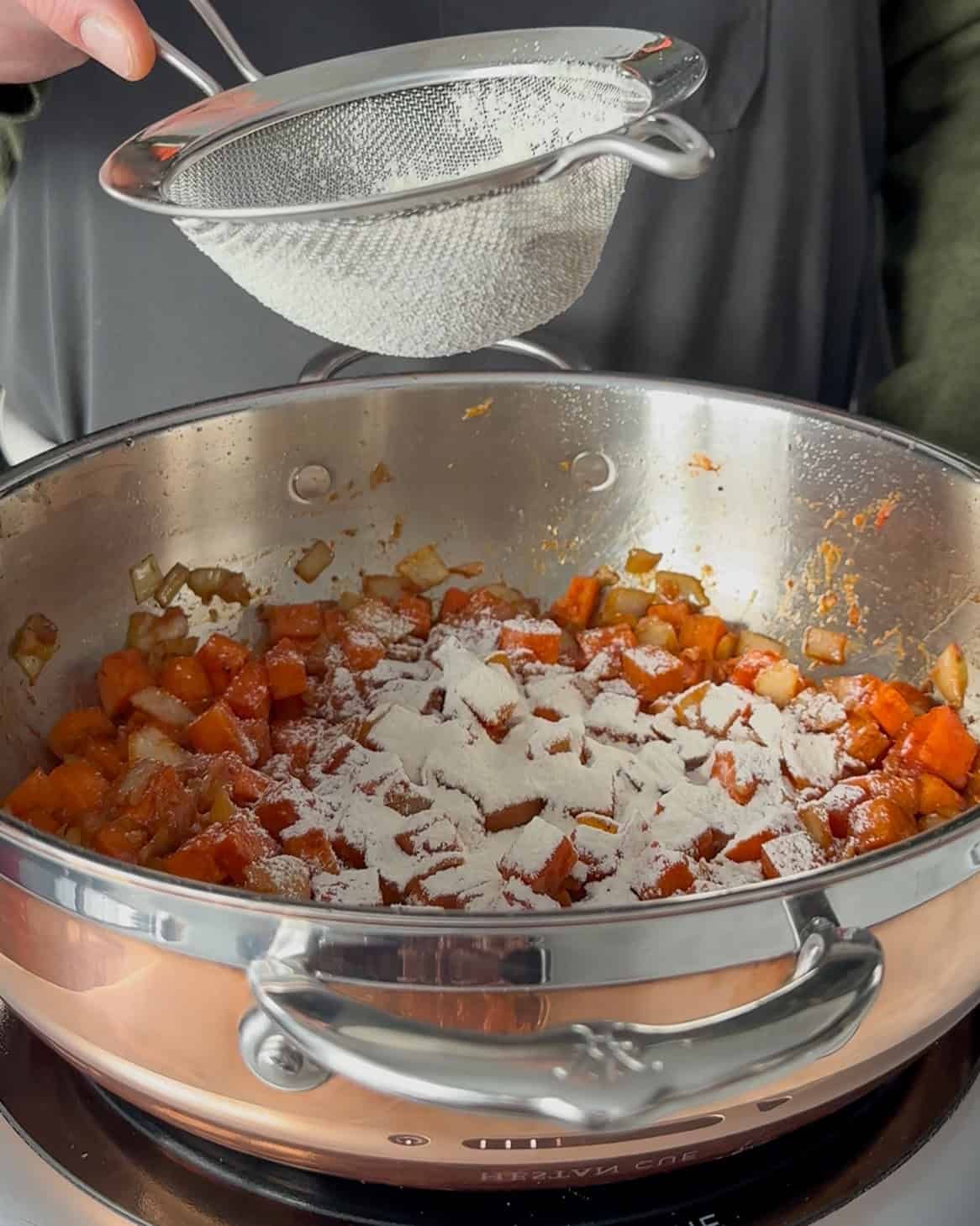 Add flour to the carrots and onions.